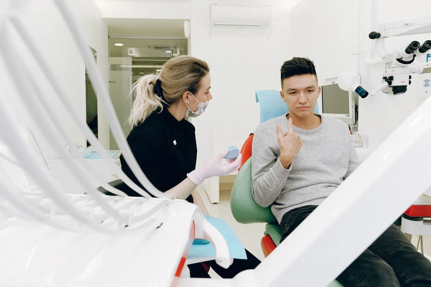 A dentist talking to a patient in the dental chair